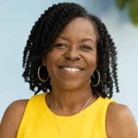Nikco_Moore seen with curly hair style and in a yellow color outfit